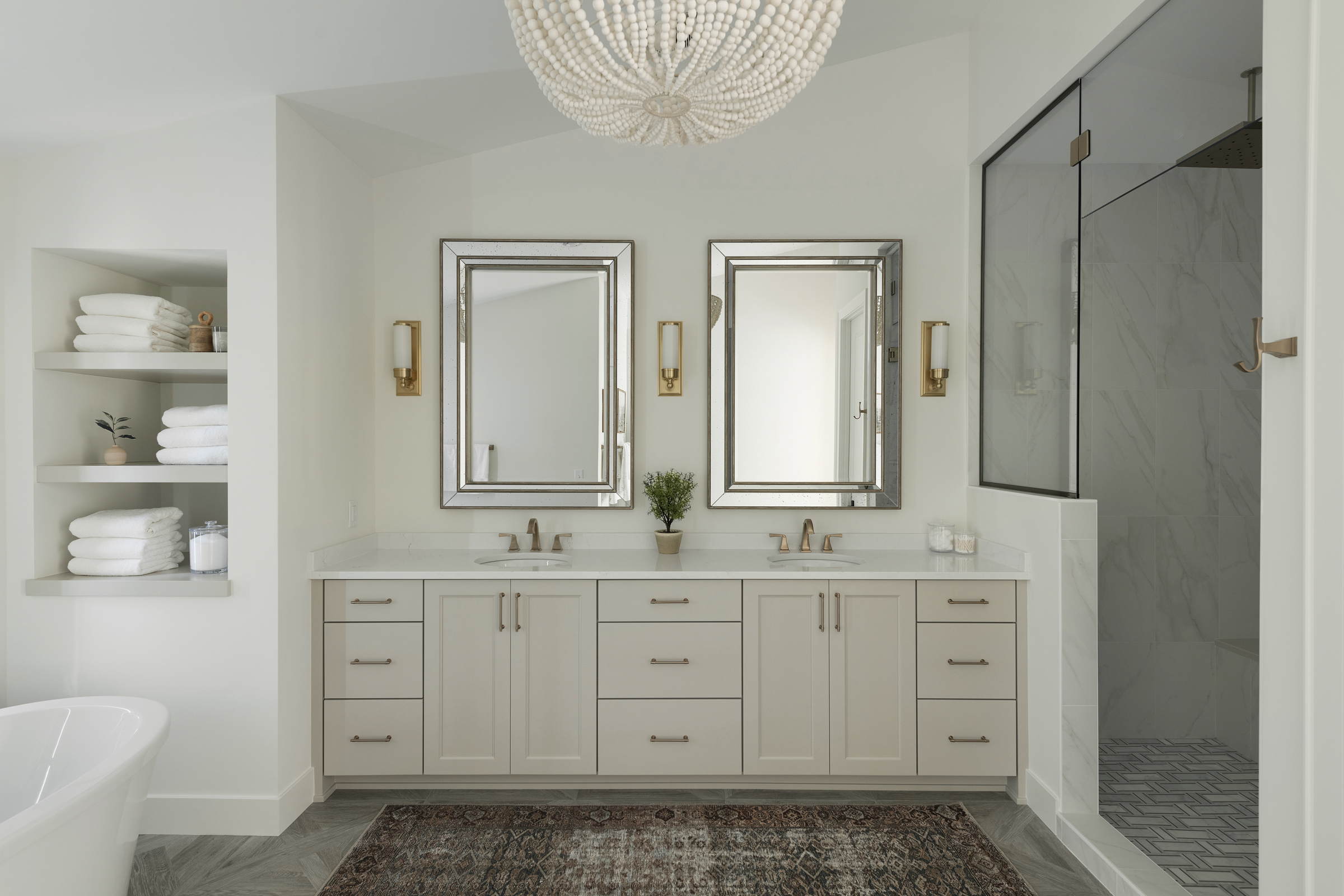 neutral primary bathroom with elegant chandelier and patterned run