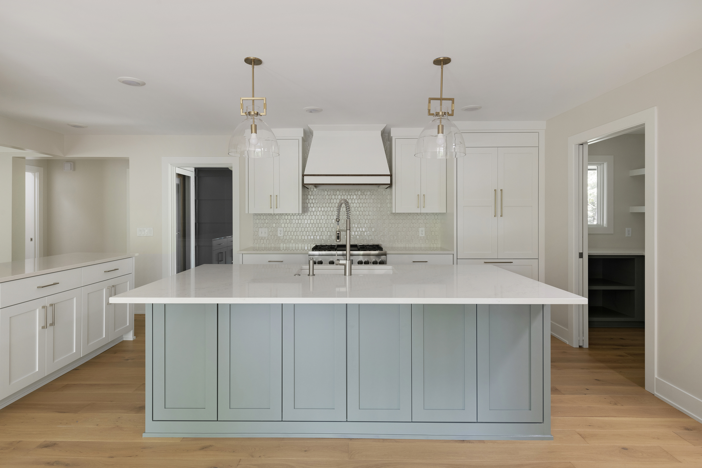 White classic kitchen with blue island cabinets